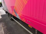 a pink truck parked on the side of the road