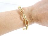 someone is wearing a gold bracelet with a twisted design on it