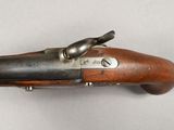 a close up of a gun on a white surface