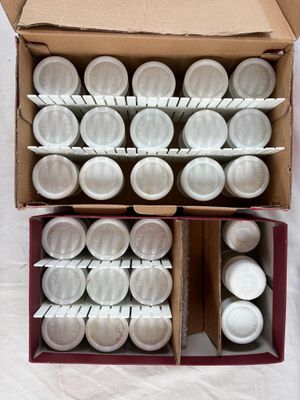 a box full of empty white cups on a table