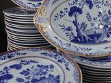 several blue and white plates are stacked on top of each other