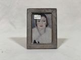 painting of a woman in a white fur coat in a silver frame
