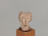 sculpture of a woman ' s head on a wooden block