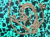 a close up of a chain on a green and black background