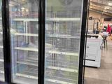 two refrigerators that are sitting in the middle of a store