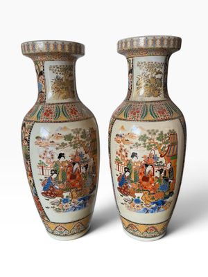 pair of oriental vases with asian scenes on them on a white background
