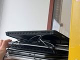 a person that is holding a laptop on a desk