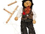 a wooden doll that is holding a string and wooden pegs