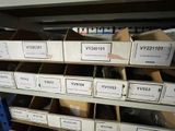 many boxes that are stacked on a shelf in a room