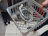 a man holding a basket with a hose in it