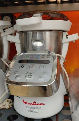 a white blender sitting on a counter next to a blender