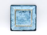 blue square ceramic dish with gold rim on white background