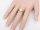 an image of a woman ' s hand with a diamond ring on it