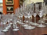 many wine glasses lined up on a table