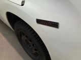 a close up of a white truck with a sticker on it