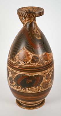 a vase with a design on it sitting on a table