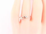 a woman ' s hand with a ring on it ' s finger
