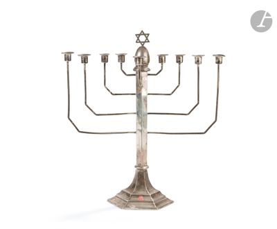 a silver metal menorat with five candles and a star of david on top