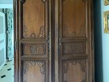 une grande armoire en bois dans le coin d'une pièce