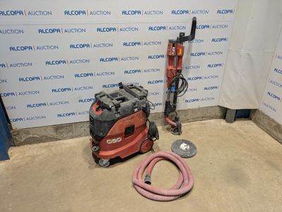a machine that is sitting on the floor next to a hose
