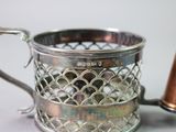 a silver cup with a copper cone next to it