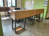 a desk with a laptop on it in an office