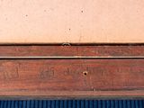 a wooden box with writing on it sitting on a blue mat