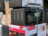 many microwaves stacked on top of each other on a pallet