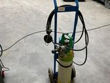 a blue cart with a gas can on it in a warehouse