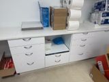 a desk with a lot of boxes and a laptop on top of it