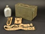 a box, a bottle, and a pair of scissors on a table