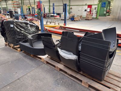 many tvs sitting on a pallet in a warehouse