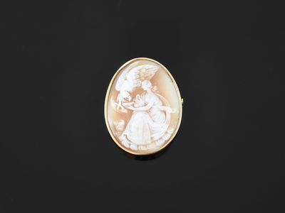 an oval shell cameo of a woman holding a child