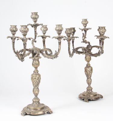 a pair of silver plated candelabs with flowers and leaves