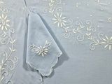 a blue table cloth with white embroidery on it