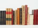 a lot of books that are stacked on top of each other