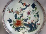 a plate with a floral design on it on a table