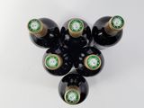 six bottles of wine are arranged in a circle on a white surface