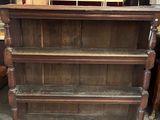 a wooden shelf that has a bunch of shelves on top of it