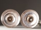two silver knobs that are sitting on a table
