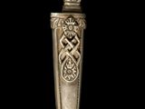 an old silver spoon sitting on top of a wooden table