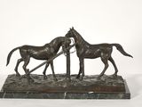 bronze sculpture of two horses pulling a plow on a marble base