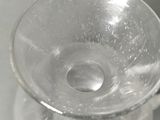 a clear glass cup with a handle sitting on a table
