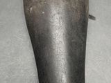 a hand holding an old, worn, black, leather shoe