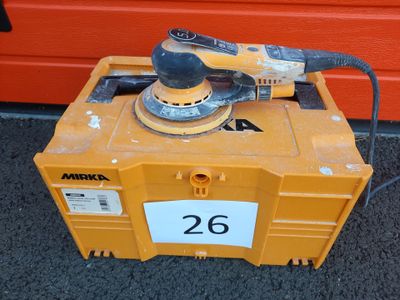 a sander sitting on top of a box with a number 26 on it