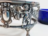 a silver bowl with a blue glass bowl in the background