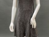 the mannequin is wearing a gray dress and a pearl necklace