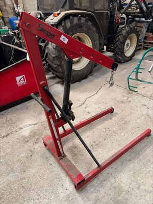 a red machine that is parked in a garage