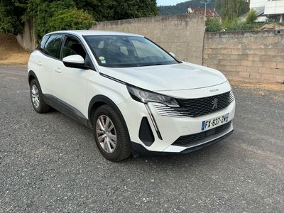 the white car is parked on the side of the road