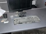 a computer desk with a keyboard and mouse on it